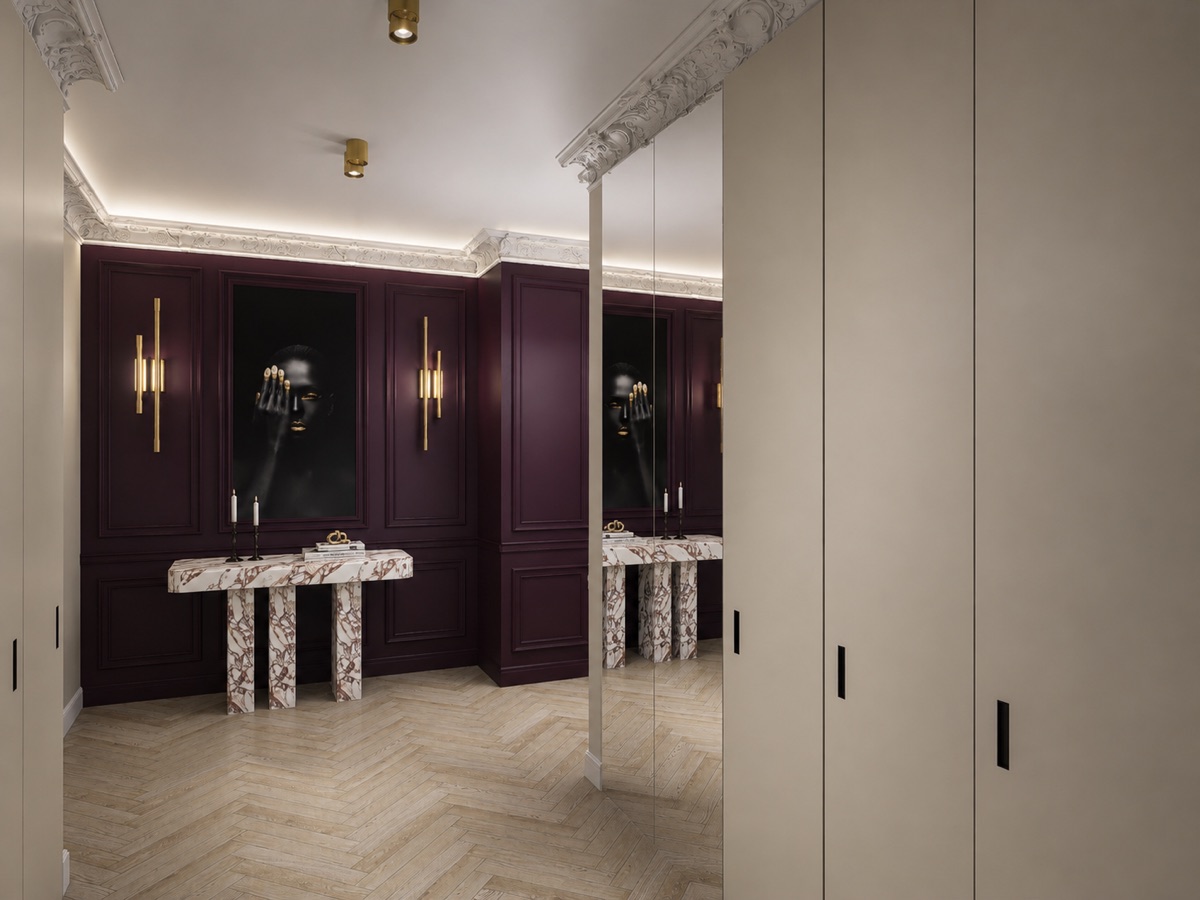 Ingresso con boiserie borgogna, consolle in marmo e armadiature a specchio